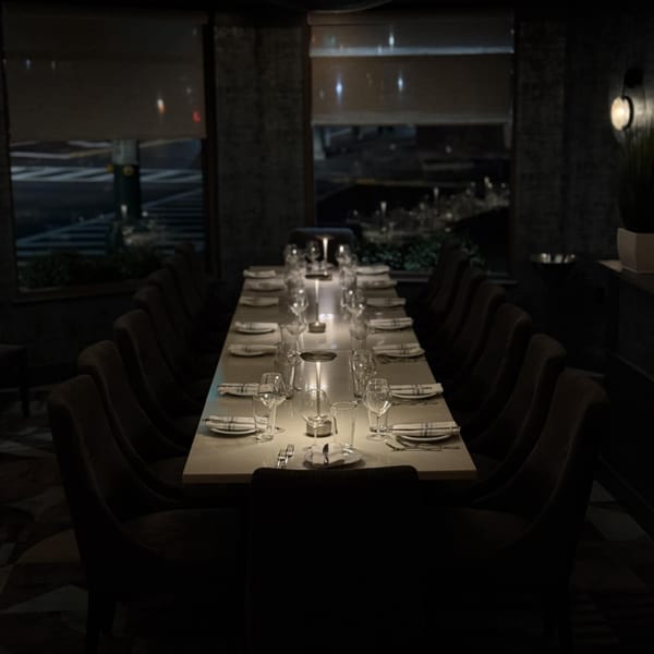 A long, dimly lit dining table set for a private event at Jessica's Italian Restaurant.